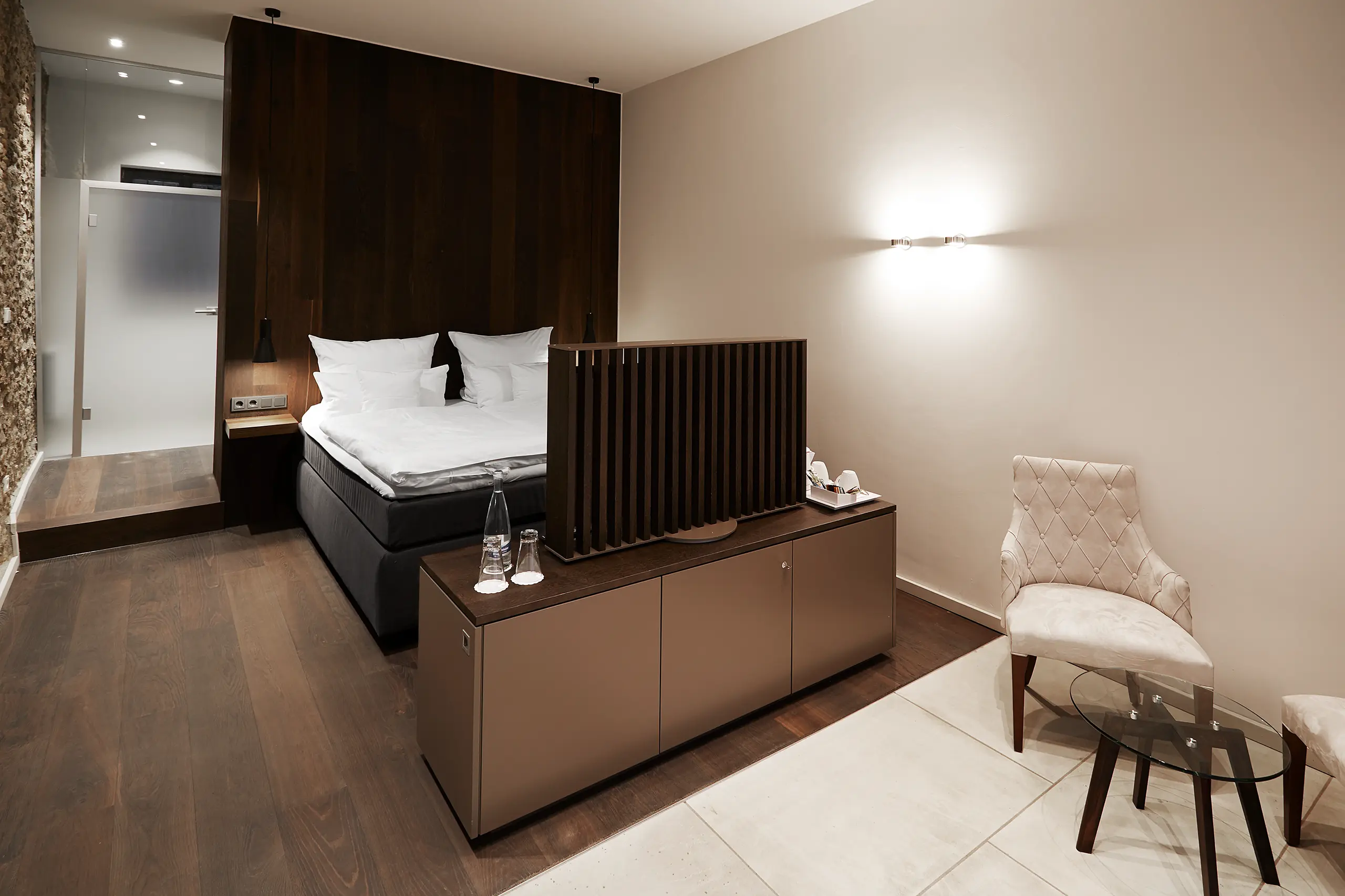 Superior-Zimmer in der Scheune mit Doppelbett, Sessel und Blick ins Bad